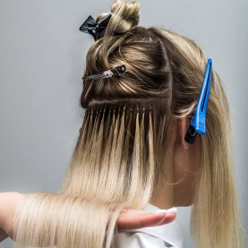 Hair extensions being applied